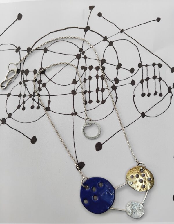 Enamelled Royal Blue Circle, Hammered Brass Circle and textured silver circle linked together to form and abstract constellation. Hung on a silver chain with handmade S hook clasp.