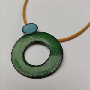 Green enamelled circle with next to small sky blue circle on a yellow leather cord.