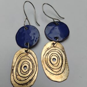 Royal blue enamelled copper circles with etched circles on irregular oval brass shapes. Hung on eco silver ear hooks